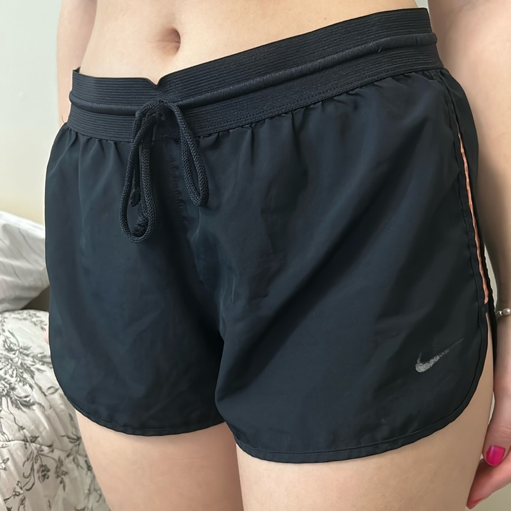 Nike black athletic shorts with orange detail